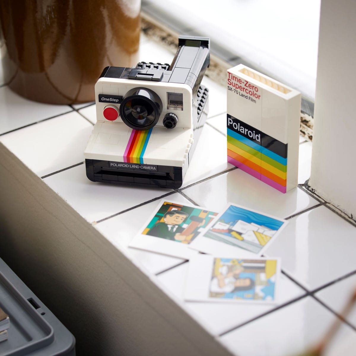 LEGO Ideas Polaroid OneStep SX-70 Camera set with 516 pieces, features a realistic build with working viewfinder, iconic Color Spectrum, turnable exposure dial, shutter button, and brick-built film pack that ejects photos