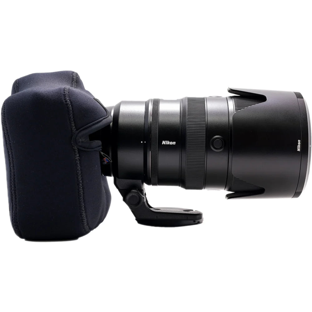 Nikon camera lens with a black protective cap on a white background