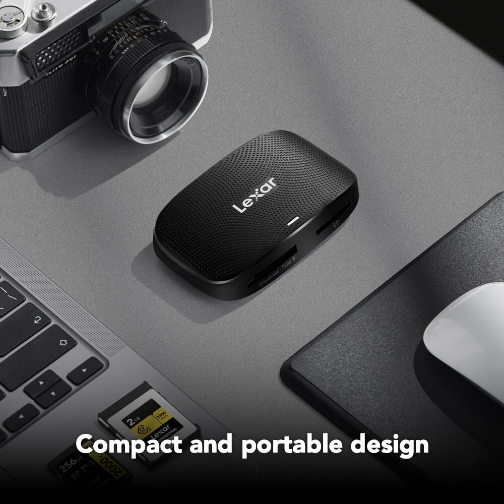 Lexar USB-C card reader on a desk with laptop, camera, and mouse.