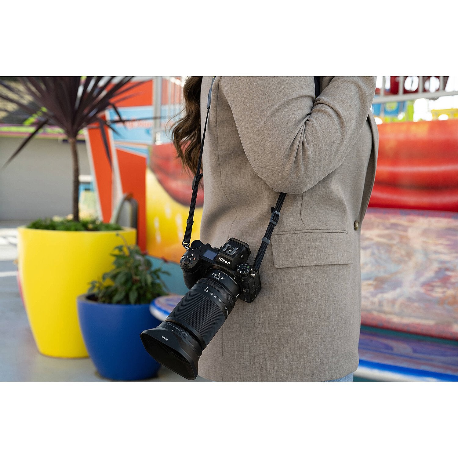 Woman carrying a Nikon camera and lens