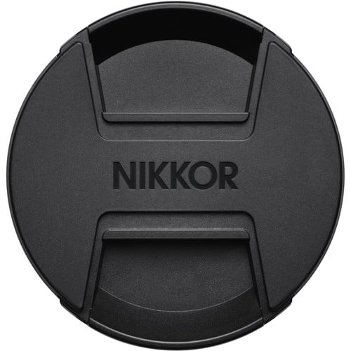 Black Nikon lens cap on a white background