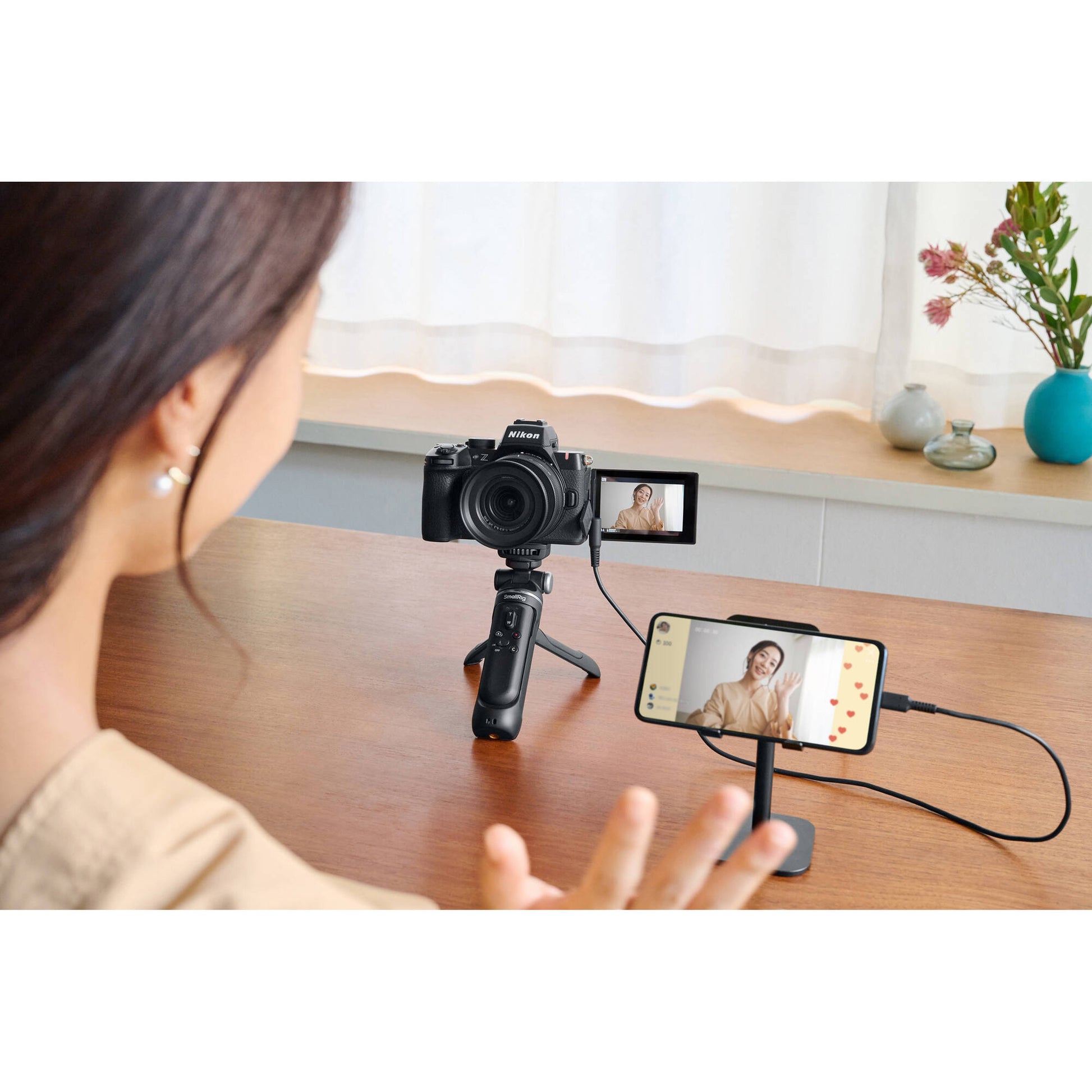 Nikon Z50 II mirrorless camera body in black, shown with a mounted lens—featuring a 3.2″ articulating touchscreen, bright OLED electronic viewfinder, textured grip, and compact APS‑C design.