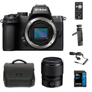 Nikon Z50 II Vlogging Kit in black featuring the Z50 II mirrorless camera body with attached NIKKOR Z 16–50 mm lens, alongside accessories including a compact vlogging LED light, shotgun microphone on cold shoe, handheld grip with wrist strap, and USB-C cable for charging.