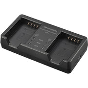 Olympus BCX-1 battery charger for BLX-1 rechargeable batteries, charges two batteries simultaneously in 150 minutes, USB-C powered with power delivery compatibility.