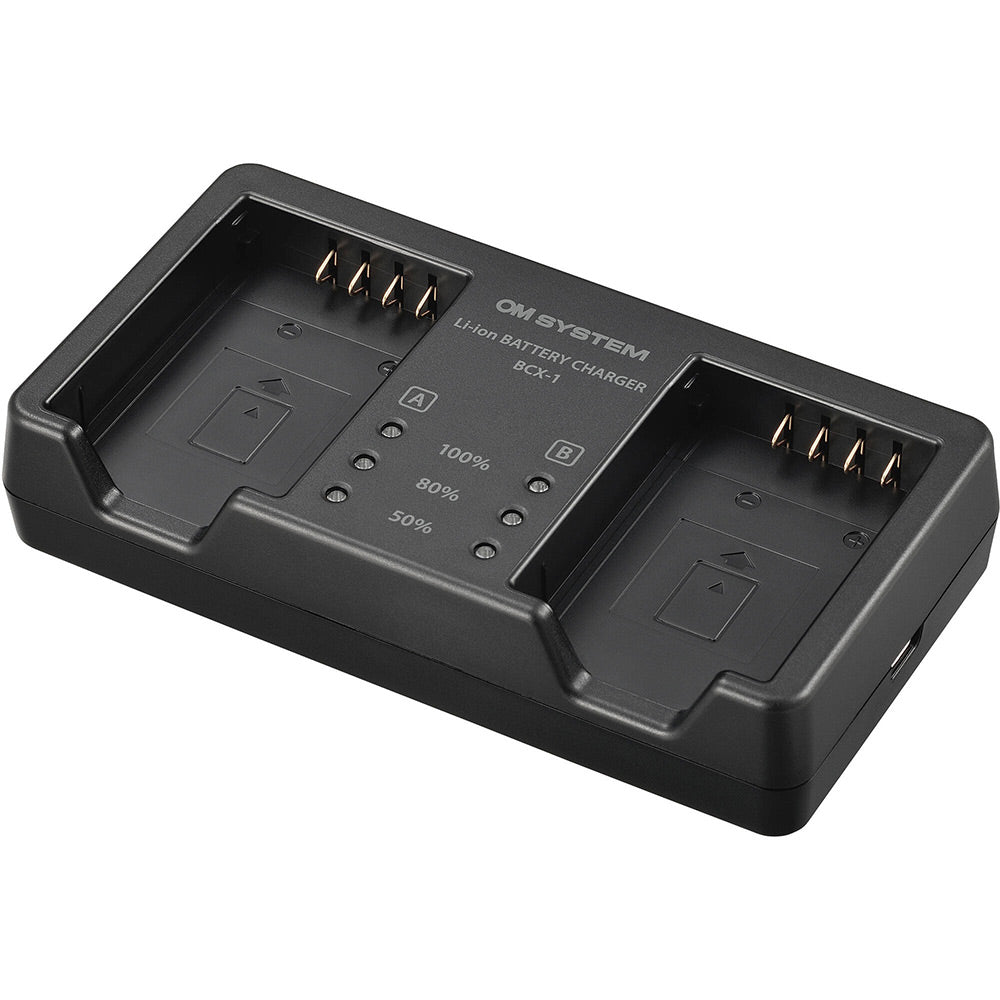 Olympus SBCX-1 kit includes one BLX-1 2280mAh lithium-ion battery and BCX-1 dual battery charger, charges two batteries simultaneously in about 150 minutes via USB-C with power delivery