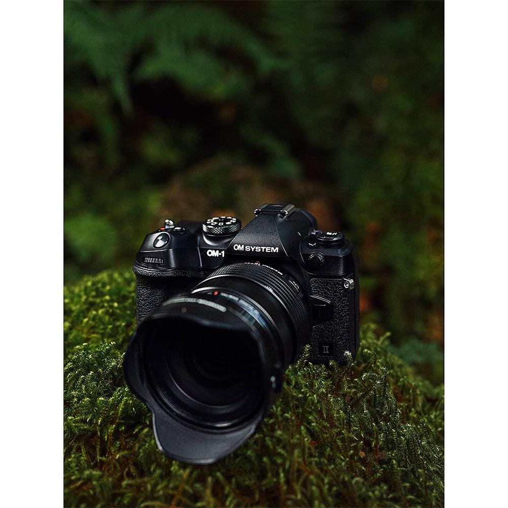 OM System OM-1 Mark II mirrorless camera with 20MP stacked BSI Live MOS sensor, TruePic X processor, 5-axis IBIS with 8.5 EV stops, 50 fps continuous shooting, 4K 60p video, and advanced AI autofocus.