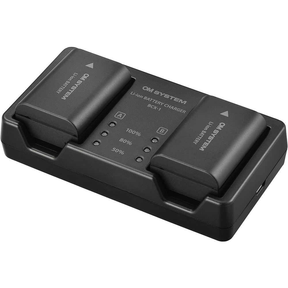 Olympus SBCX-1 kit includes one BLX-1 2280mAh lithium-ion battery and BCX-1 dual battery charger, charges two batteries simultaneously in about 150 minutes via USB-C with power delivery