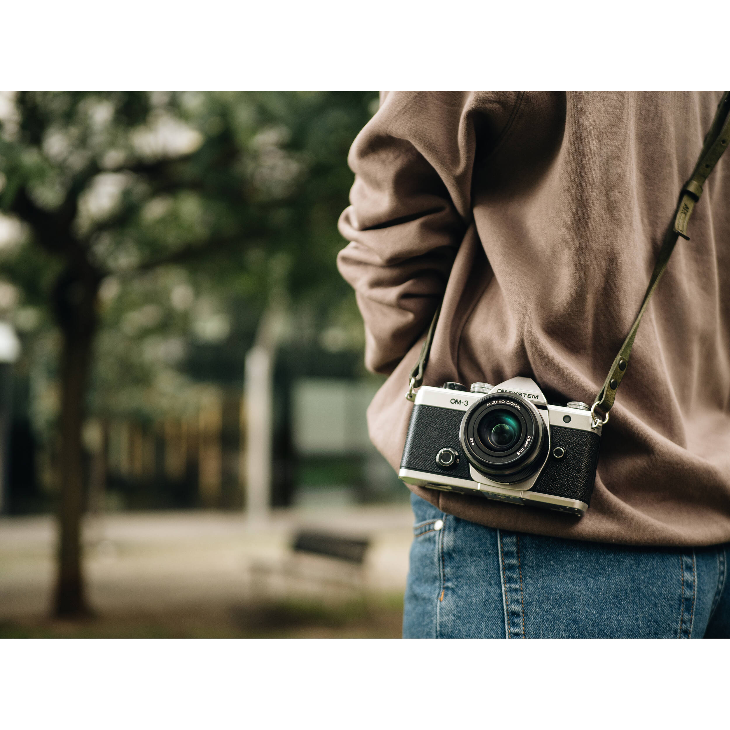 OM System OM-3 mirrorless camera with 20MP stacked BSI Live MOS sensor, TruePic X processor, 1053-point Quad Pixel AF covering 100% frame, up to 50 fps continuous AF burst, 4K 60p video, IP53 weather sealing, and 3-inch vari-angle touchscreen.