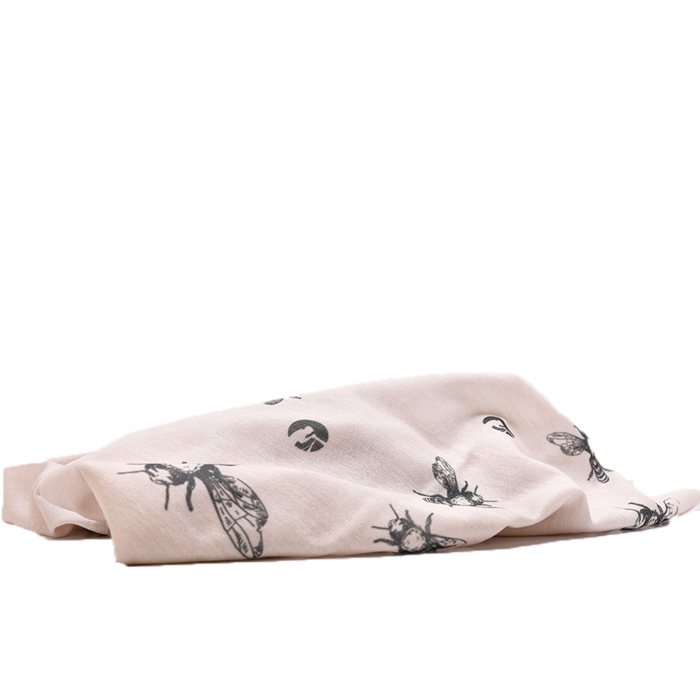 Folded fabric with black insect patterns on a white background