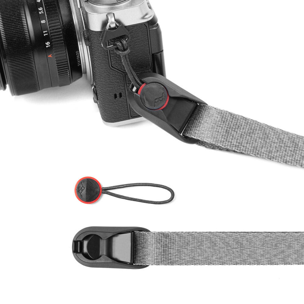 Peak Design Leash camera strap in Ash color, adjustable length from 83 to 145 cm, slim nylon webbing with leather accents, quick-adjust aluminum sliders, quick-release anchors rated for 90 kg, versatile for neck, shoulder, or cross-body carry.