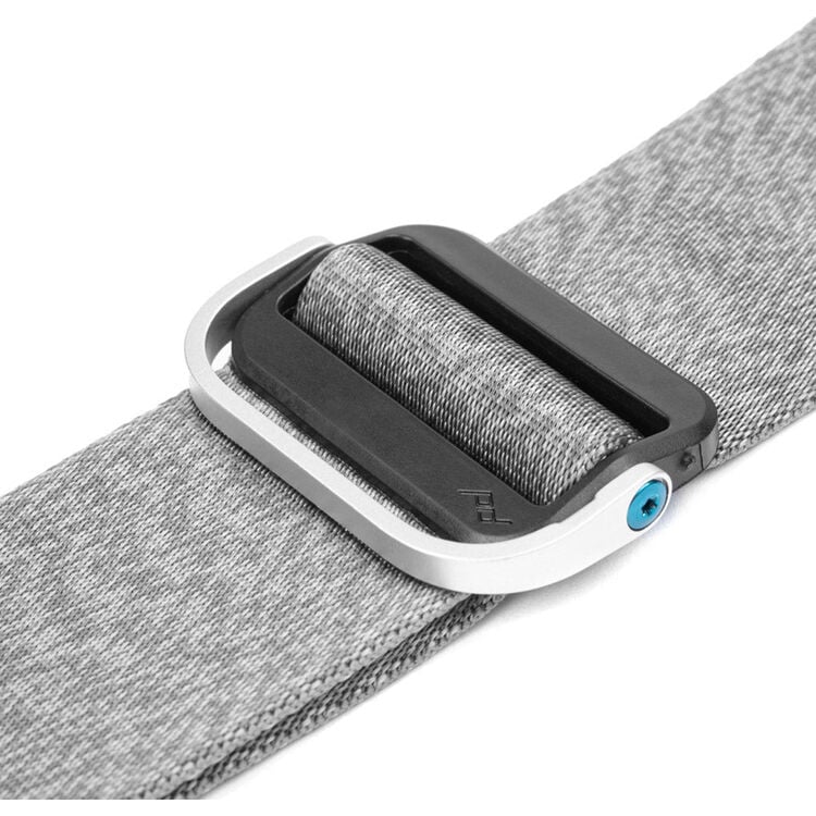 Peak Design Slide camera strap in Ash color, adjustable length 99-145 cm, 4.6 cm wide padded nylon webbing with smooth and grippy reversible sides, quick-connect Anchor Link system, supports up to 90 kg, usable as sling, neck, or shoulder strap.