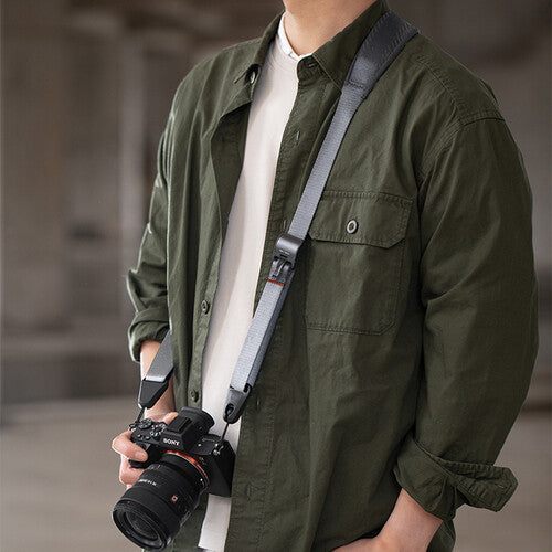 PGYTECH Camera Strap in Rock Grey featuring padded shoulder support, quick-release buckles, and adjustable length for DSLR and mirrorless cameras.