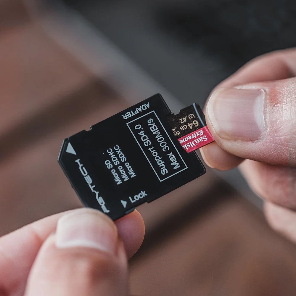 Person holding a microSD card and adapter with 'Eversant' branding.