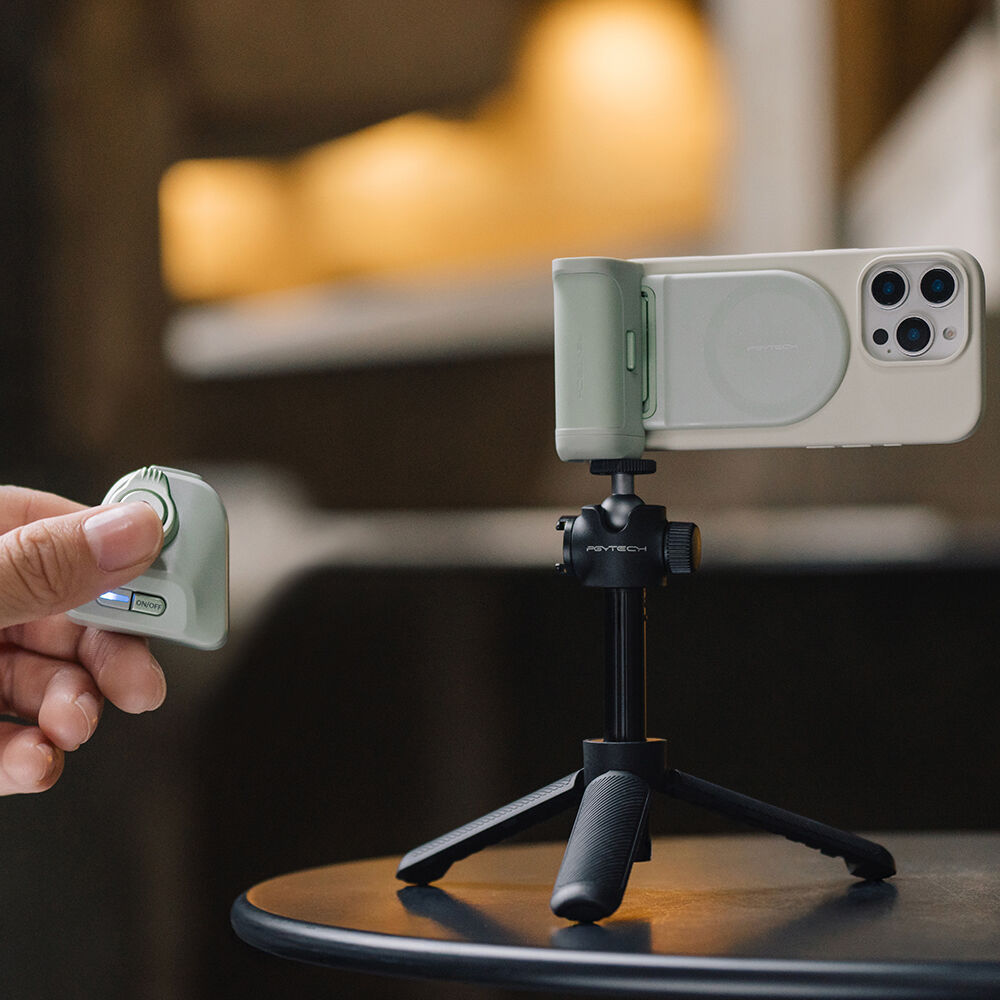 PGYTECH MagCam Phone Grip in grey with modular design including wireless charging, Bluetooth remote, ergonomic camera grip, and 3000mAh power bank.