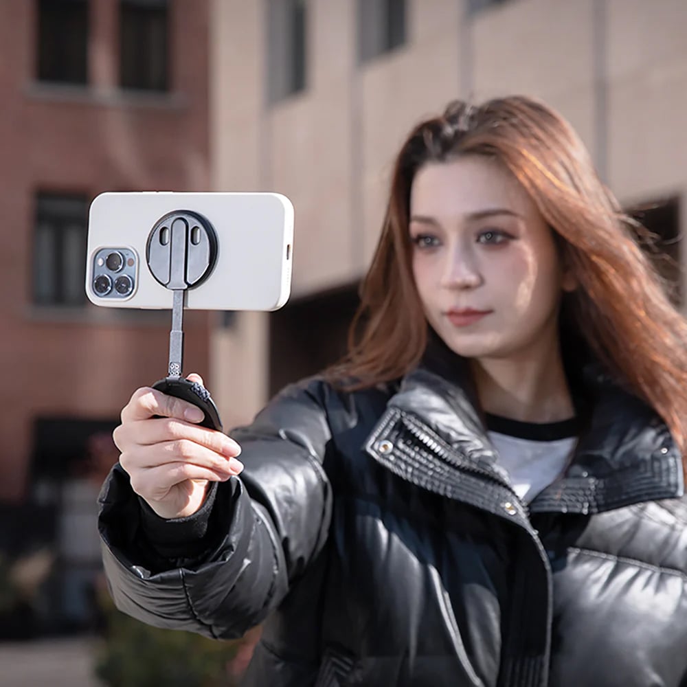 PGYTECH MagFlex Phone Photography Stand in black with ultra-slim 6.1mm design, strong magnetic ring compatible with MagSafe, infinite rotating shaft, and extendable handle for shooting.