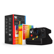 Polaroid Now Generation 2 Starter Set in black featuring classic design with 2-lens autofocus, self-timer and double exposure modes, built-in flash, rechargeable battery, made with 40% recycled materials, includes USB-C charging cable, wrist strap, and two packs of Polaroid i-Type instant film.