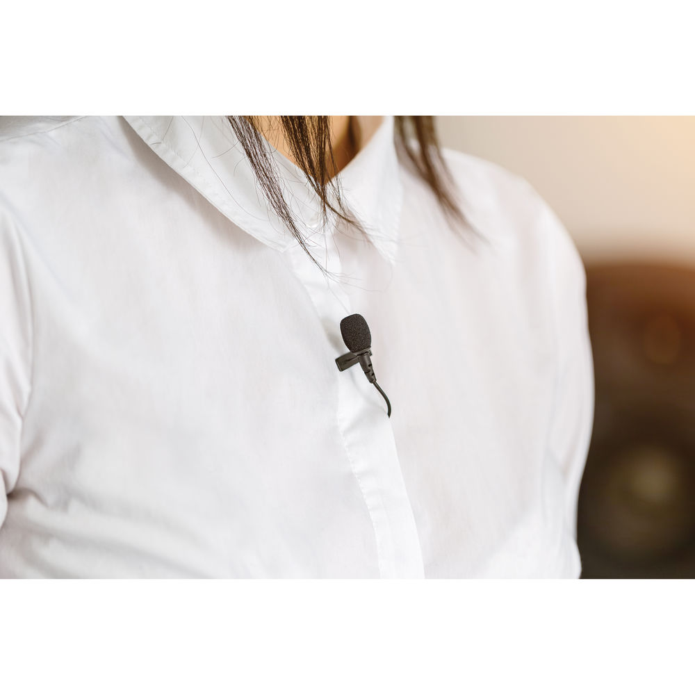 Rode Lavalier microphone attached to a white shirt with a blurred background