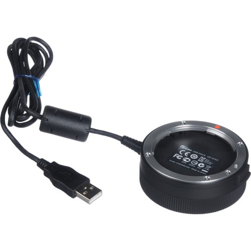 Black camera lens adapter with USB cable on a white background