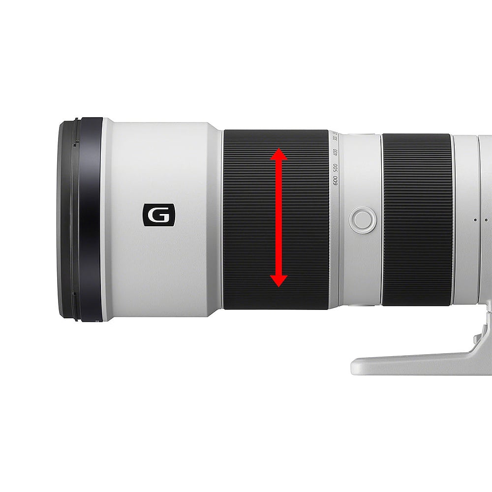 Camera lens with a red arrow indicating focus area on a white background