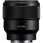 Black camera lens with 'FE 1.8/85' text on a white background