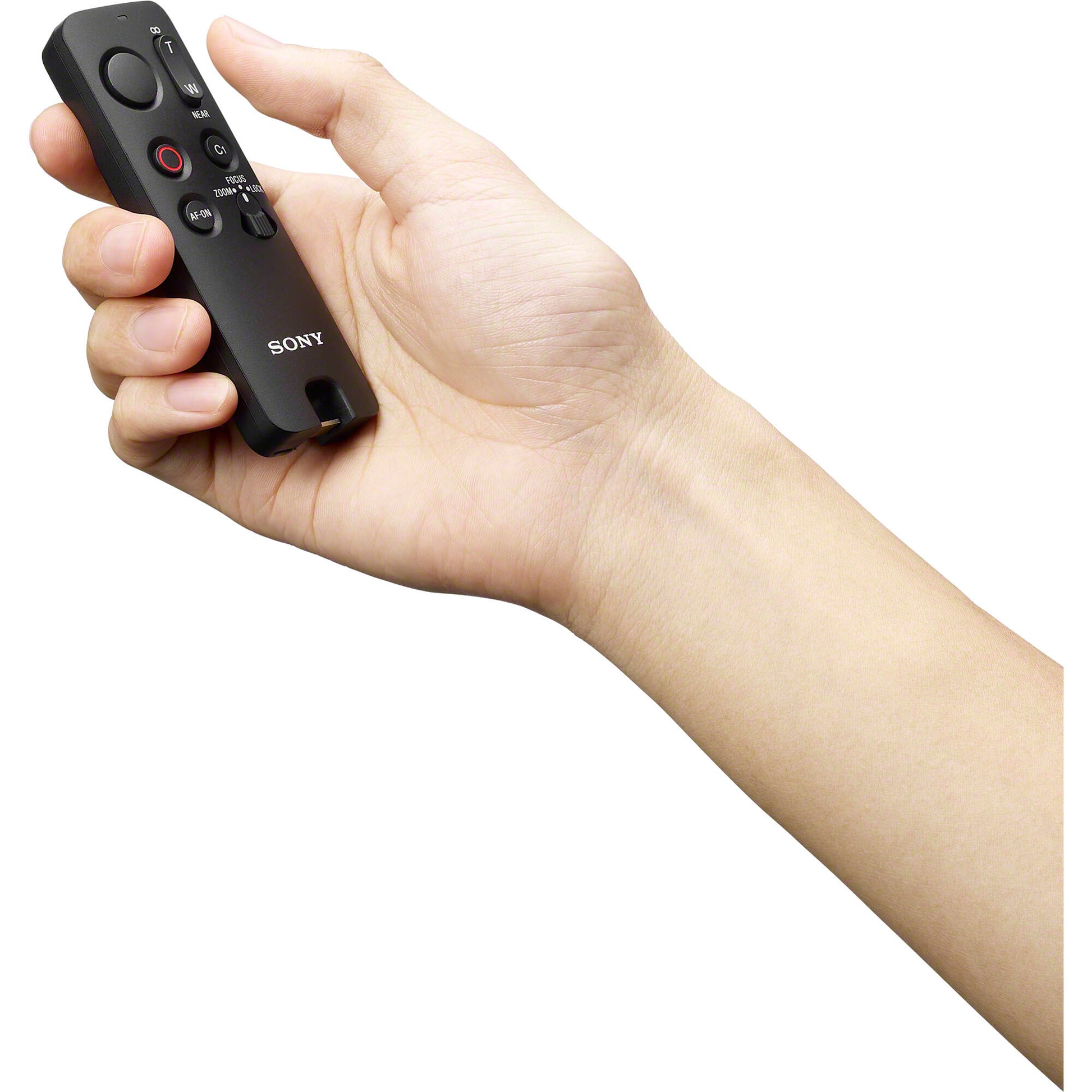 Sony RMT-VP2 wireless remote commander with Bluetooth connectivity, 10m operating range, one-handed control buttons for shutter, movie recording, autofocus, customizable C1 button, zoom/focus rocker, LED status indicator, dust and moisture resistant design, compatible with Sony Alpha cameras and selected Xperia smartphones.
