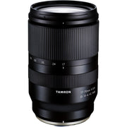 Black camera lens with 'Tamron' branding on a white background