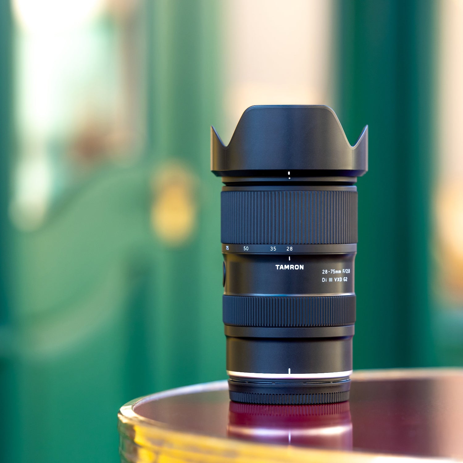 Camera lens on a reflective surface with a blurred background