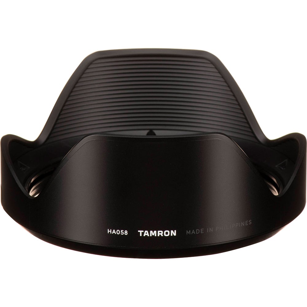 Black camera lens hood with Tamron branding on a white background