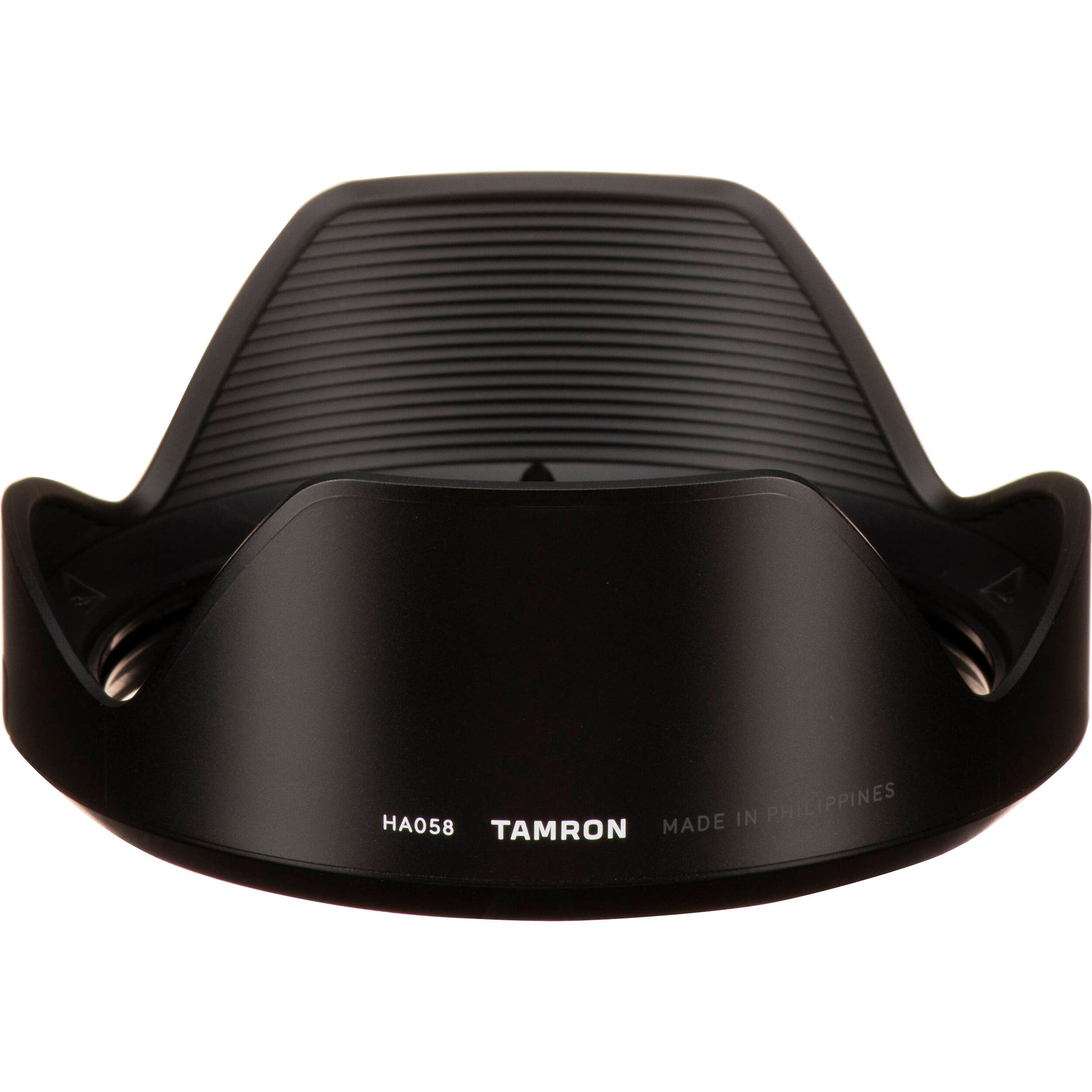 Black camera lens hood with Tamron branding on a white background
