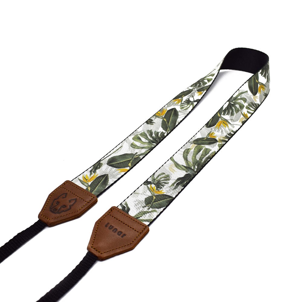 The Lunar Tropical camera strap is inspired by South African flora, featuring its native Strelitzia flower and Monstera. Shop beautiful camera straps online.