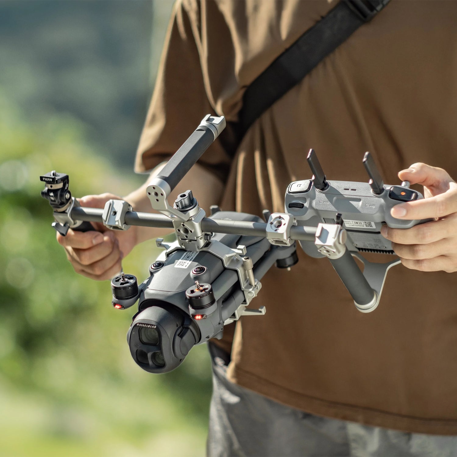 Modular camera cage with accessory mounts and audio integration for DJI Mavic 4 Pro.
