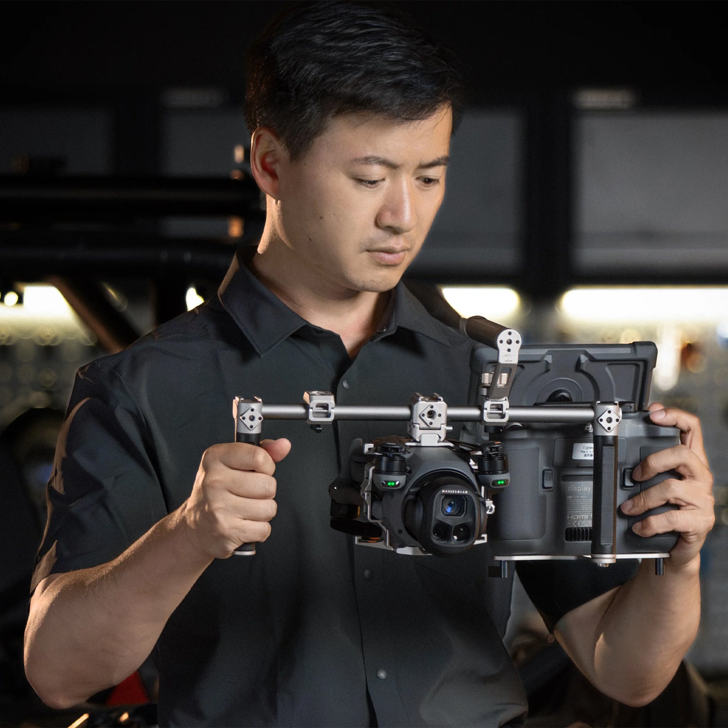 Modular camera cage with accessory mounts and audio integration for DJI Mavic 4 Pro.