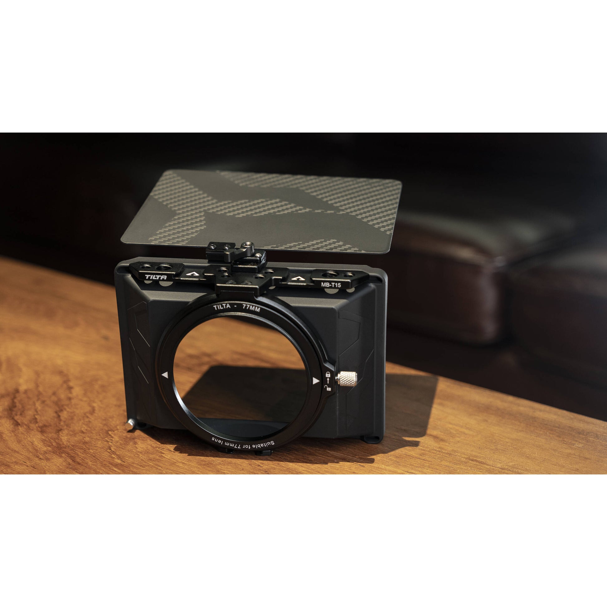 Camera lens hood on a table with a blurred background