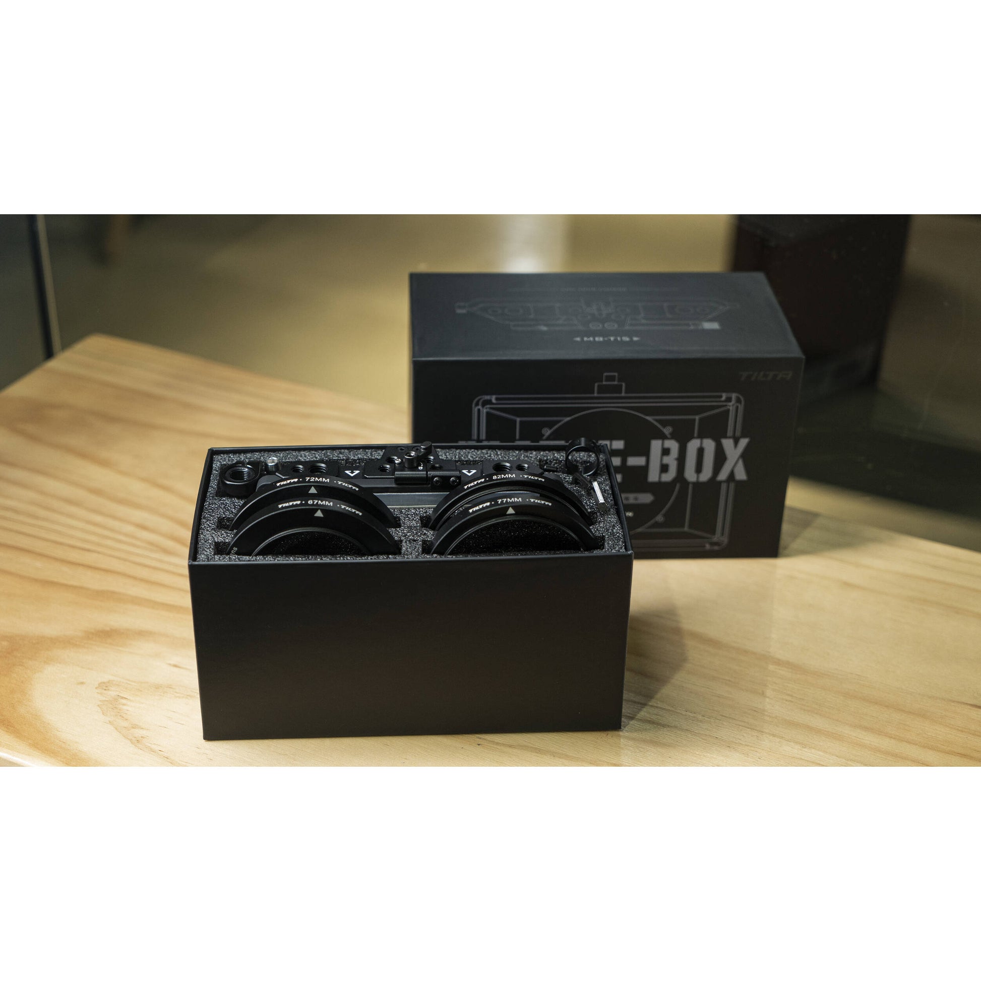 Black box with lenses on a table, branded Tilta, Matte-Box.