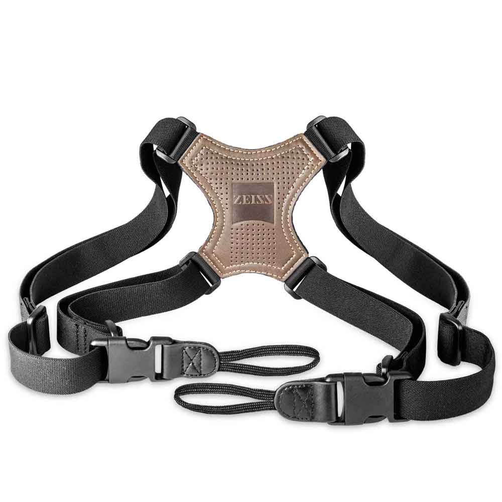 Black camera harness with brown leather patch featuring 'Zeiss' logo on a white background