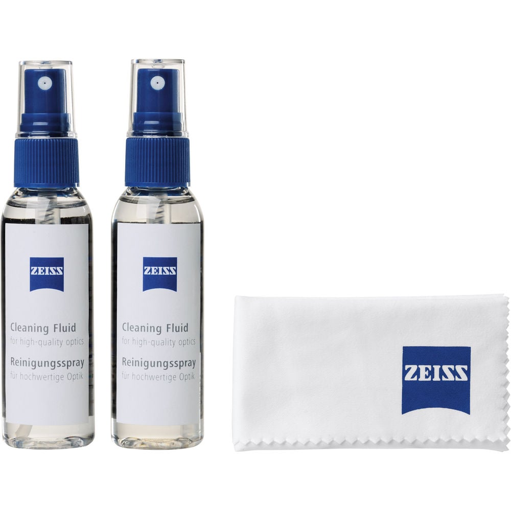 Two Zeiss cleaning fluid bottles and a cloth on a white background