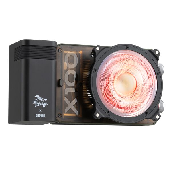 Zhiyun X100 RGB compact handheld video light with mini lens reflector and magnetic barn doors for even, vibrant lighting.