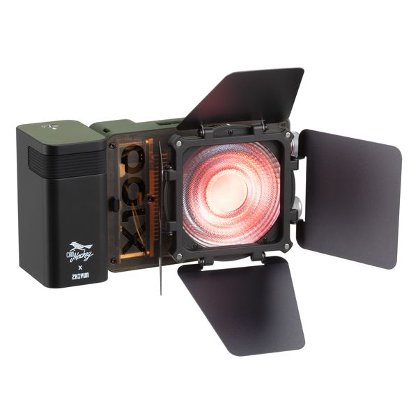 Zhiyun X100 RGB compact handheld video light with mini lens reflector and magnetic barn doors for even, vibrant lighting.