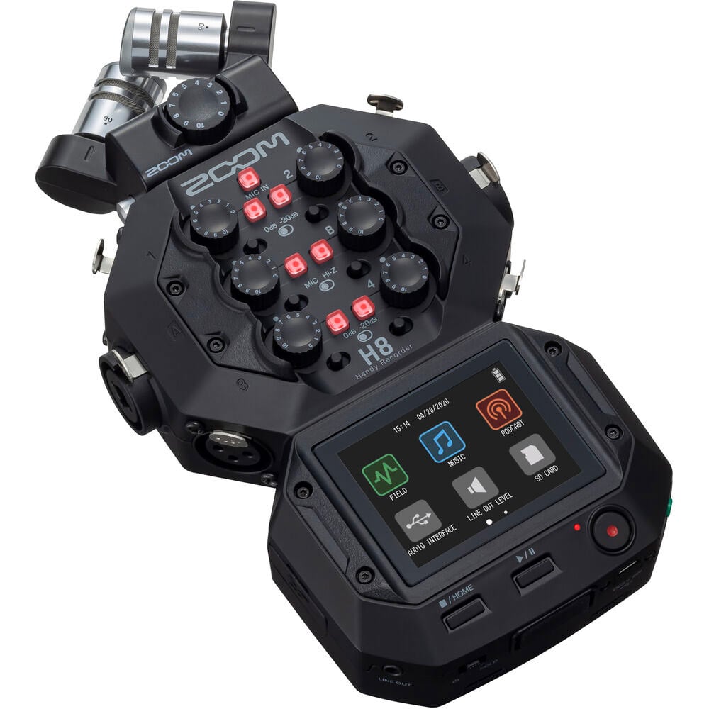Zoom H8 portable handy recorder showing its color touchscreen, X/Y mic capsule, multiple input gain knobs, outputs and buttons, viewed at slight angle against a neutral background.
